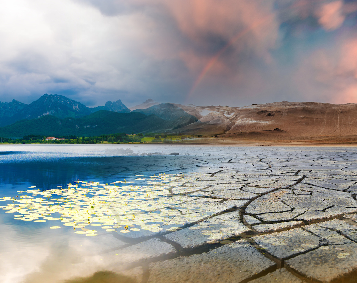 Landscape with mountains and a lake and a dried desert. Global climate change concept